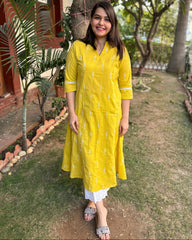 Mustard embroidered A-line kurta with pockets.