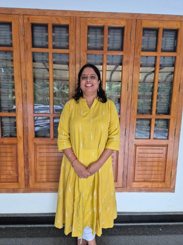 Mustard embroidered A-line kurta with pockets.