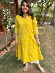 Mustard embroidered A-line kurta with pockets.