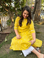 Mustard embroidered A-line kurta with pockets.