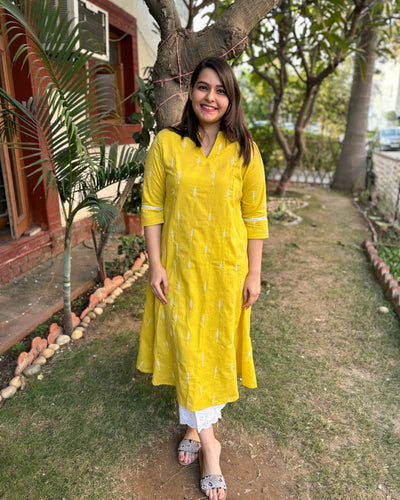 Mustard embroidered A-line kurta with pockets.