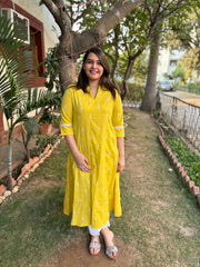 Mustard embroidered A-line kurta with pockets.