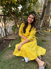 Mustard embroidered A-line kurta with pockets.