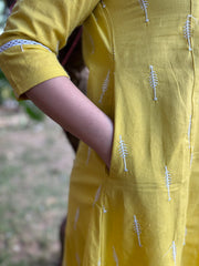 Mustard embroidered A-line kurta with pockets.