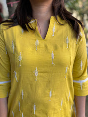 Mustard embroidered A-line kurta with pockets.