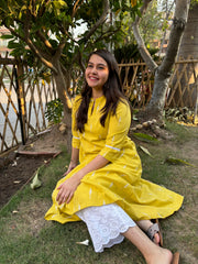 Mustard embroidered A-line kurta with pockets.