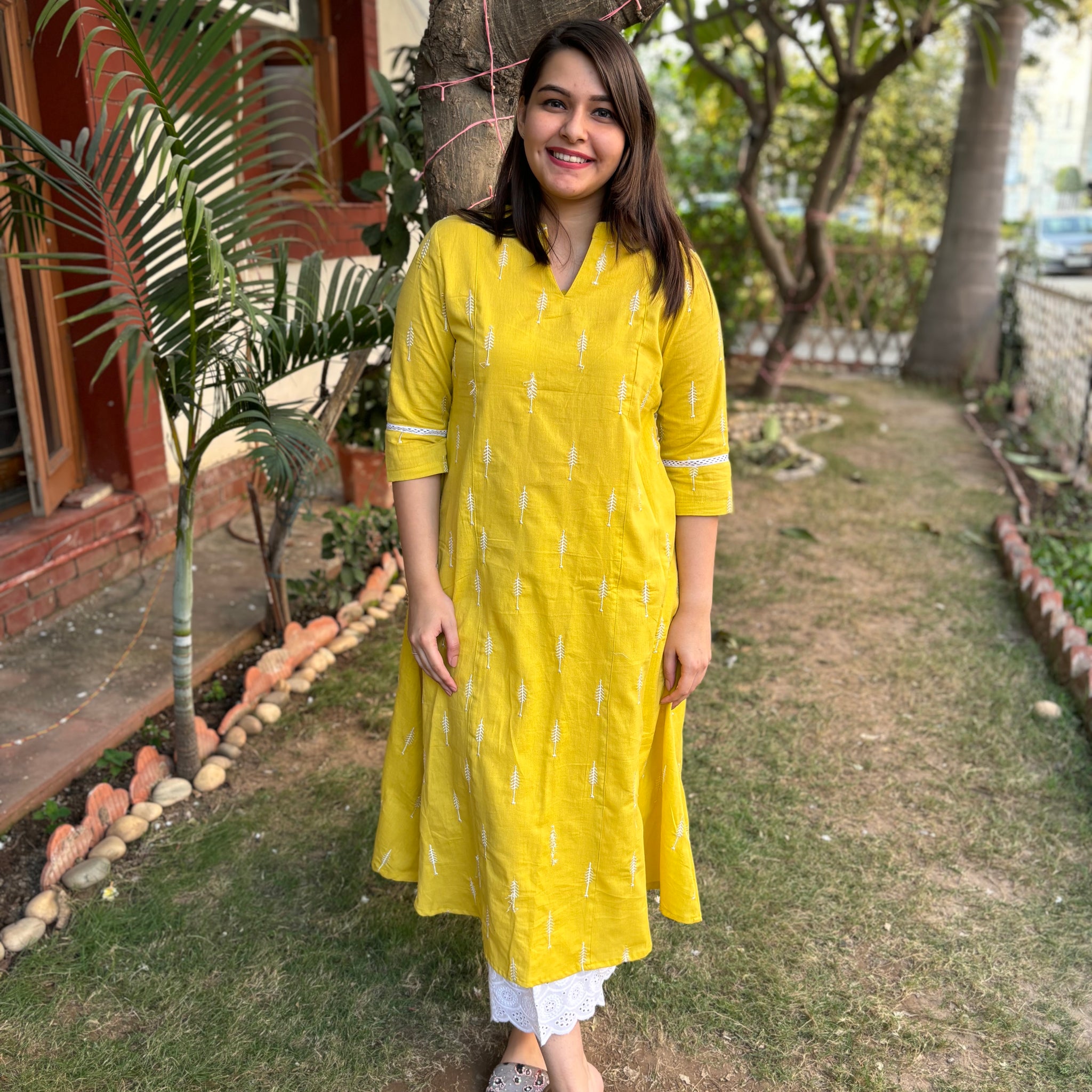 Mustard embroidered A-line kurta with pockets.