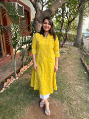 Mustard embroidered A-line kurta with pockets.