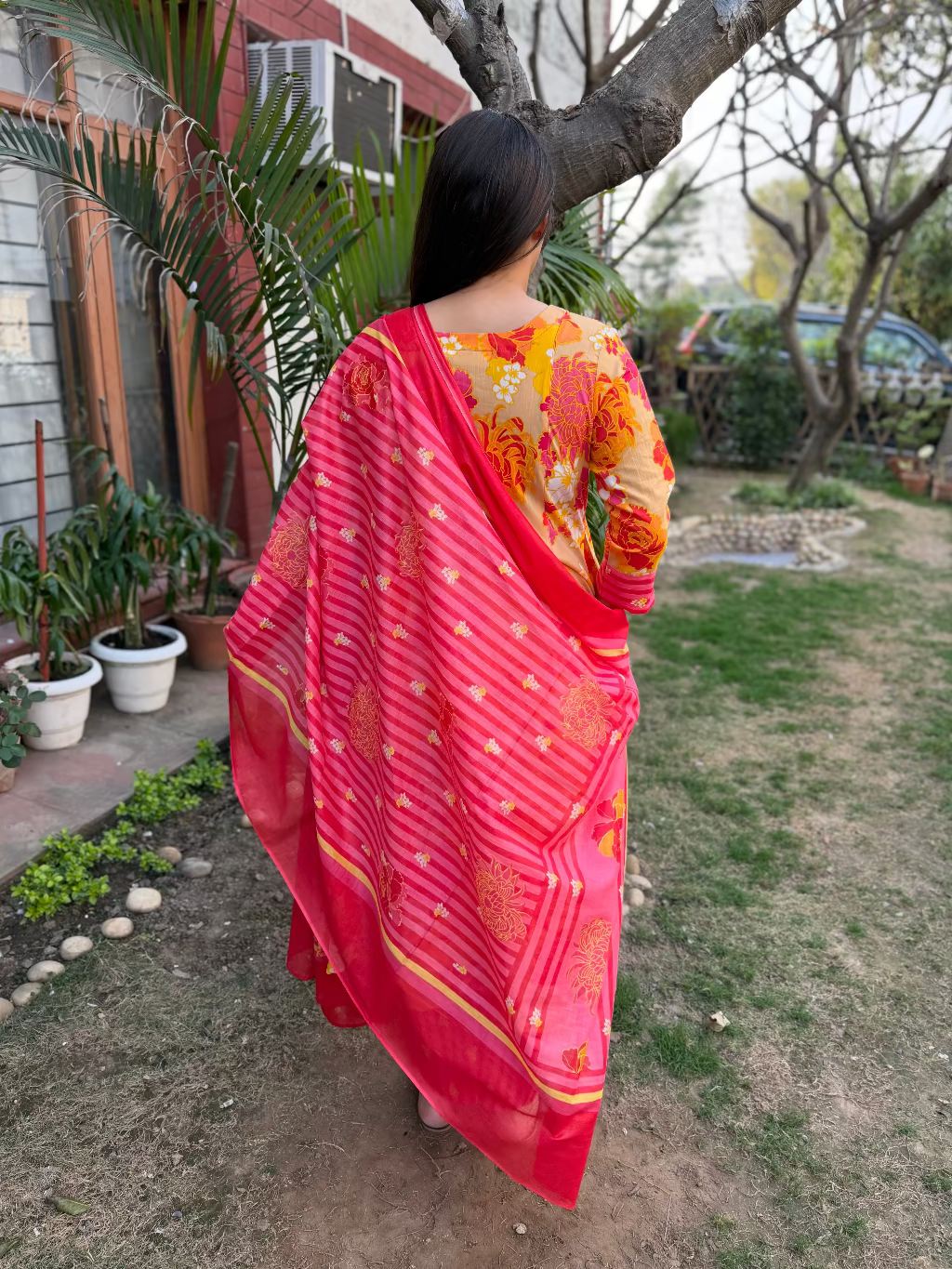 Orange Multi Flower A-line Suit Set from the back by Sanskritam